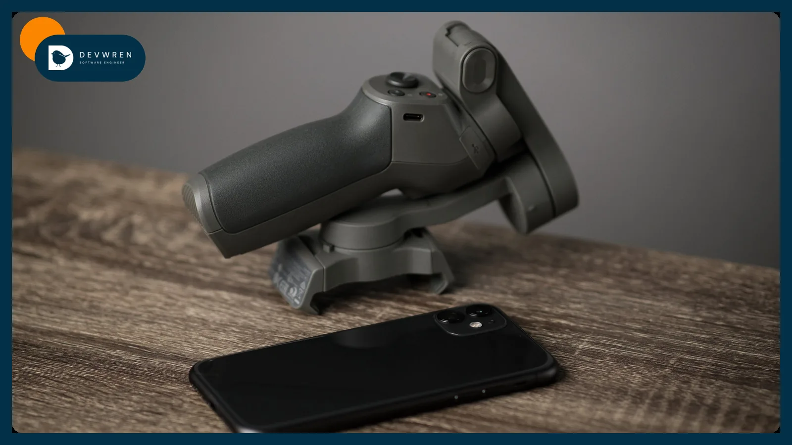 A smartphone and a phone gimbal for filming video on a wooden table